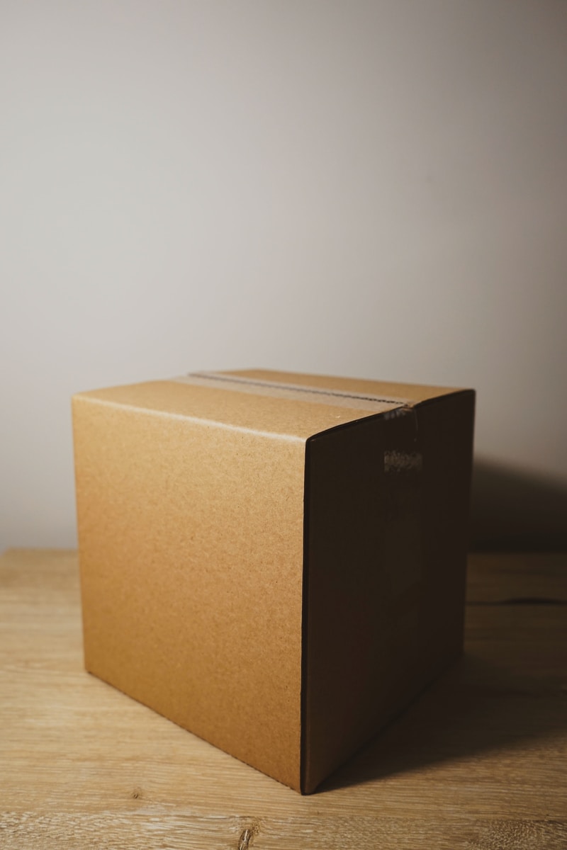 shallow focus photo of brown cardboard box