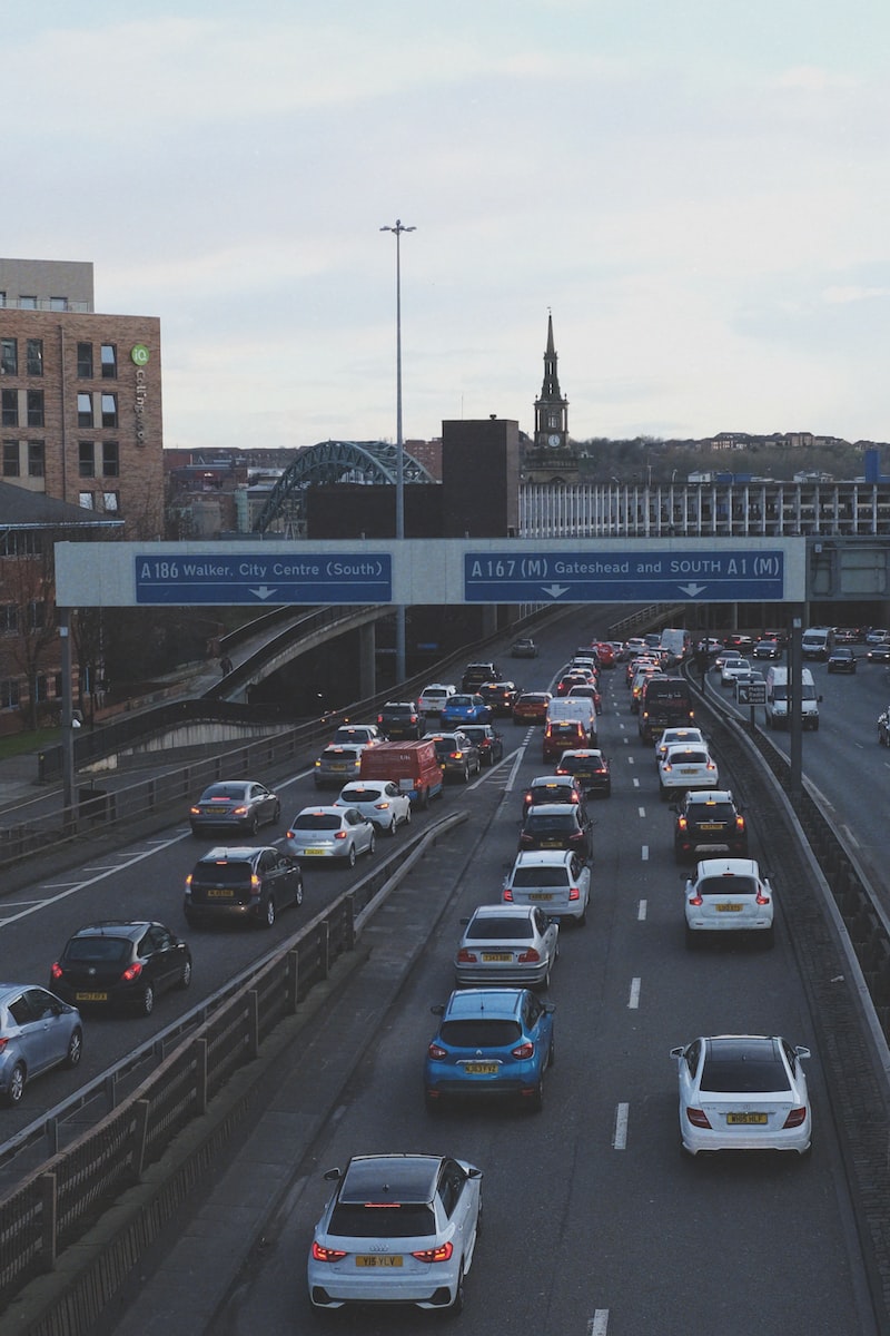 cars on road near bridge during daytime